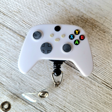 Load image into Gallery viewer, reflections by zana african american badge retractable id badge holder Xbox controller ID retractable badge reel gaming-themed badge holder gamer accessory Xbox enthusiast ID reel controller-shaped badge reel gaming pride badge holder unique badge reel design ID holder for gamers Xbox controller emblem gaming accessory retractable badge reel for gamers Xbox logo badge reel gaming community ID accessory gamer gear badge reel gaming and ID functionality Xbox controller design badge reel
