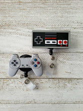 Load image into Gallery viewer, reflections by zana african-american badge retractable id  nintendo controller badge reel retro gaming id holder vintage nintendo nostalgia original gaming controller reel classic nintendo id badge holder 8-bit gaming nostalgia retro gamer retractable badge nintendo console-inspired badge reel old-school gaming id holder vintage controller retractable reel nostalgic nintendo accessory 80s gaming badge reel gamer nostalgia id holder collectible nintendo badge reel
