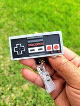 Load image into Gallery viewer, reflections by zana african-american badge retractable id  nintendo controller badge reel retro gaming id holder vintage nintendo nostalgia original gaming controller reel classic nintendo id badge holder 8-bit gaming nostalgia retro gamer retractable badge nintendo console-inspired badge reel old-school gaming id holder vintage controller retractable reel nostalgic nintendo accessory 80s gaming badge reel gamer nostalgia id holder collectible nintendo badge reel

